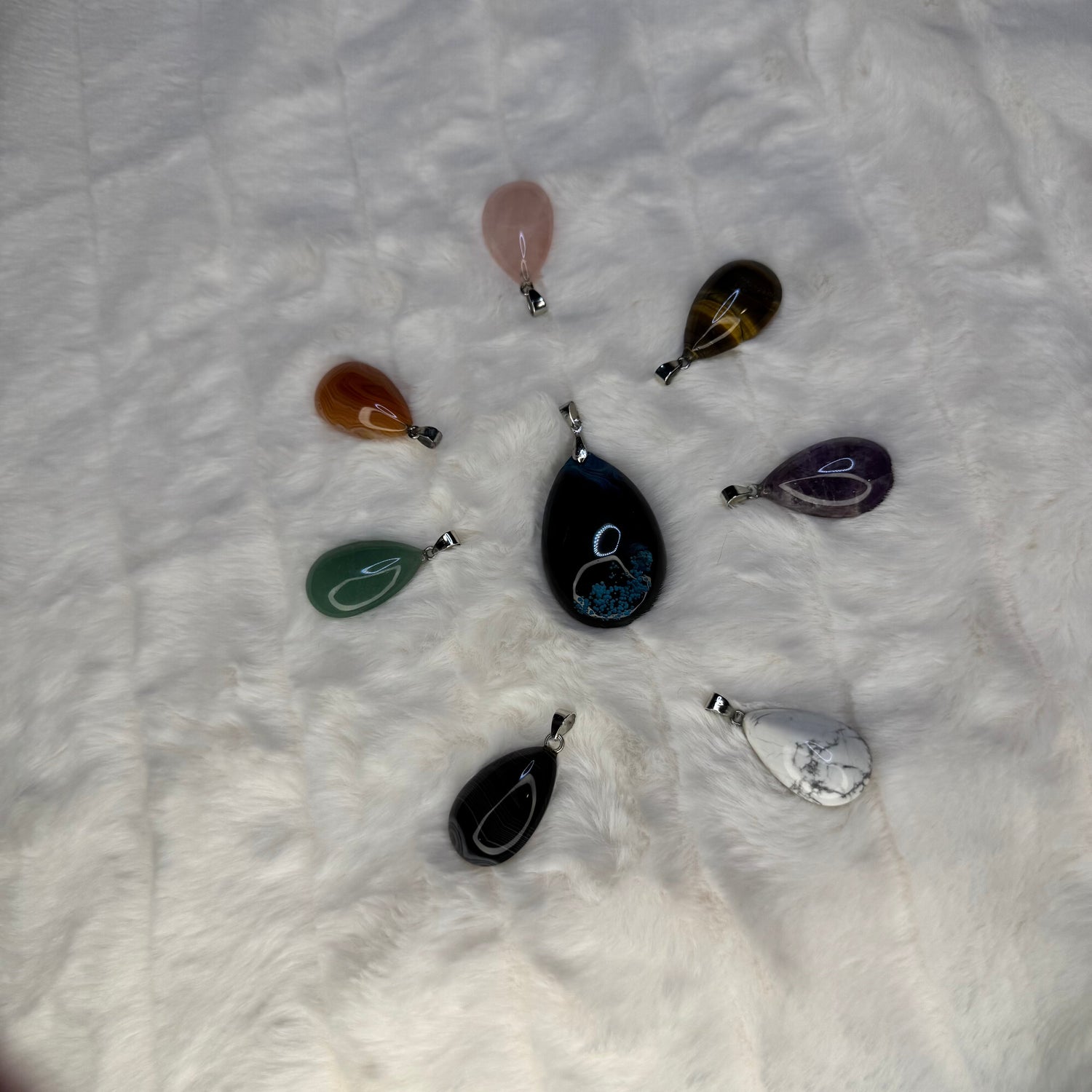 8 color full tear drop shaped pendant in a circle showing all of the potential colors available.